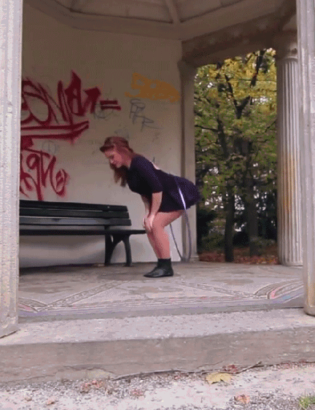 Girl hula hoops on bum