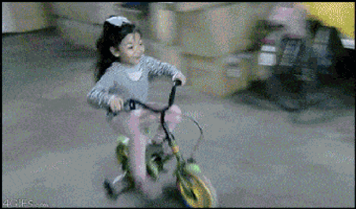 A cute toddler on a bike